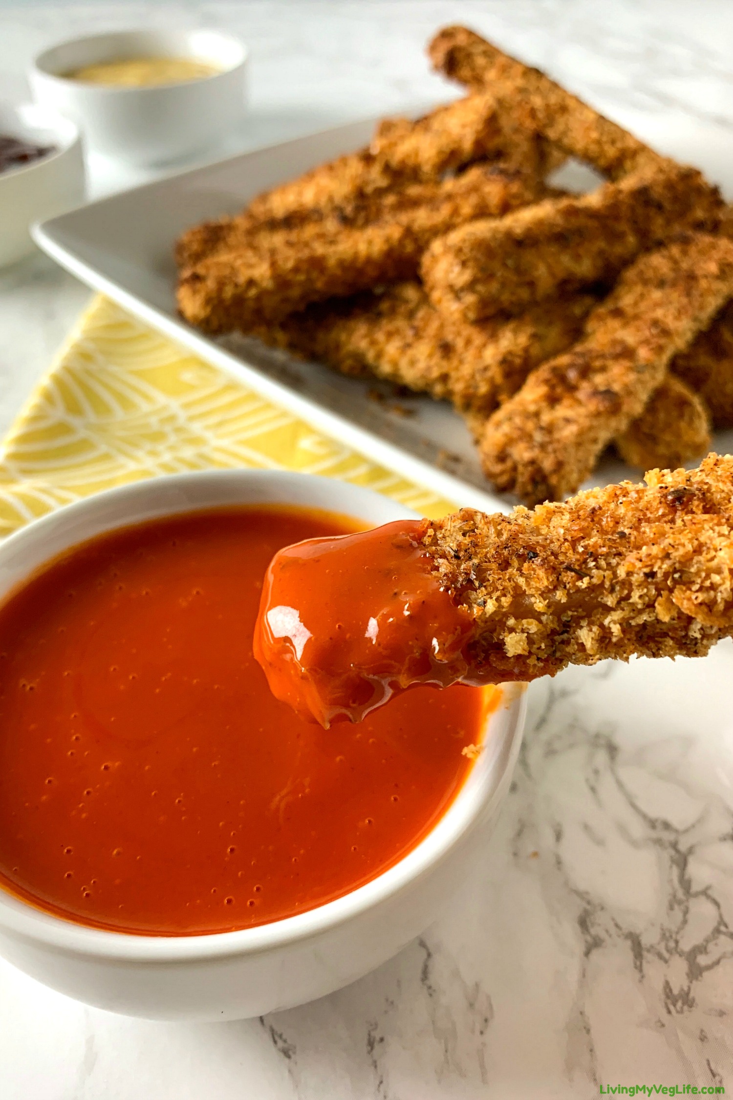 baked tofu fries dipped in sauce