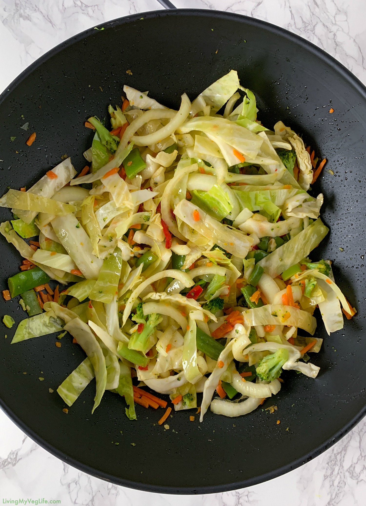 wok with stir fry vegetables and cabbage and onions