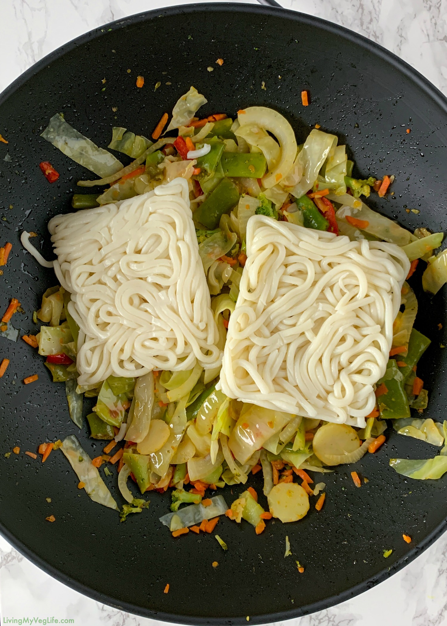 wok stir fry vegetables and cabbage and noodles with udon noodles added